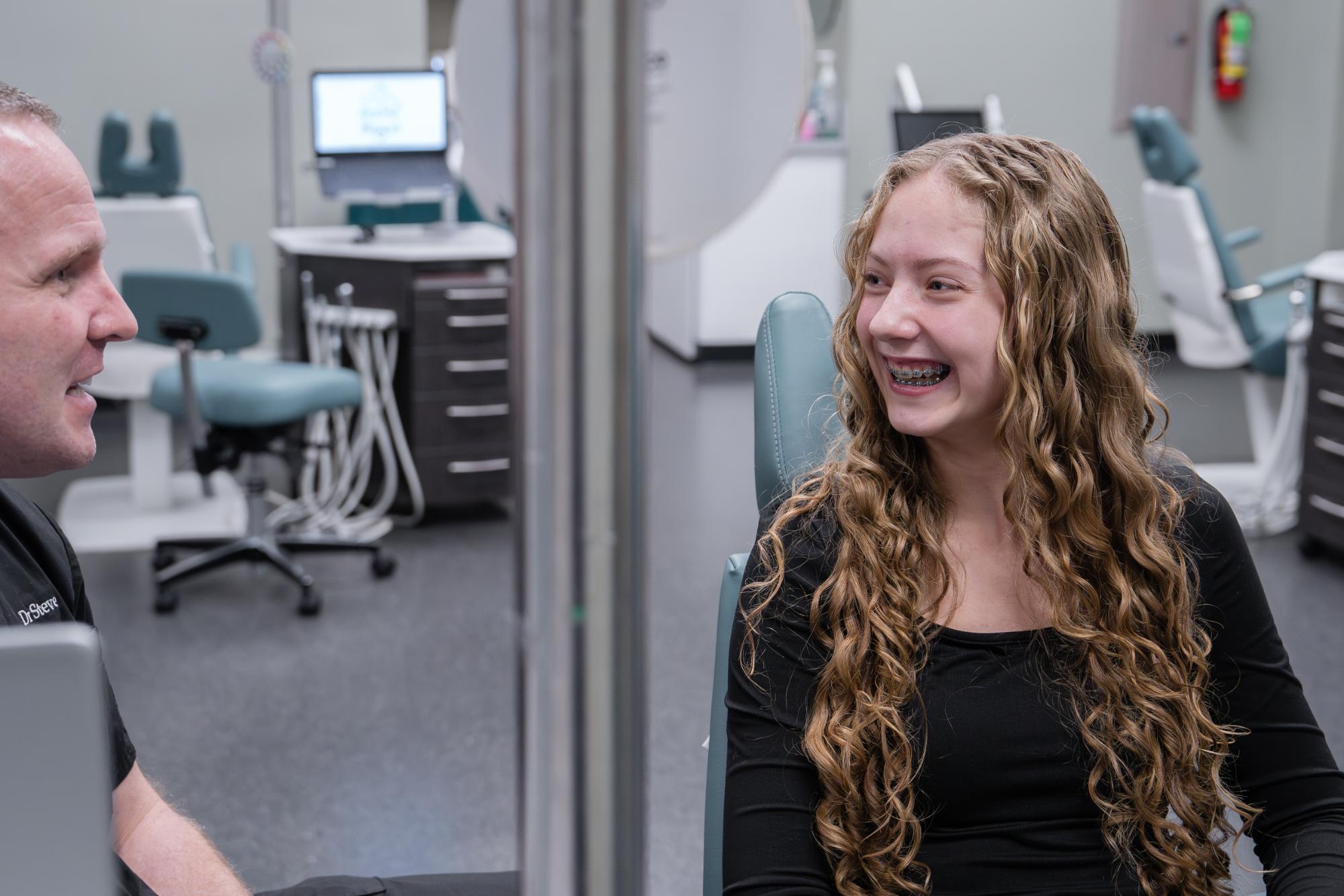 Dr. Steve Clawson consulting with a young patient wearing braces at Comfort Dental Braces, showcasing personalized orthodontic care in Federal Way, WA.
