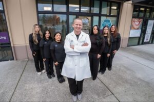 Dr. Steve Clawson with orthodontic team outside Comfort Dental Braces in Federal Way, WA, showcasing braces services.