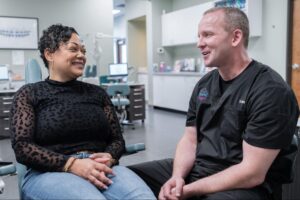 Patient consultation at Comfort Dental Braces with Dr. Steve Clawson, showcasing friendly interaction in a modern orthodontic office in Federal Way, WA.